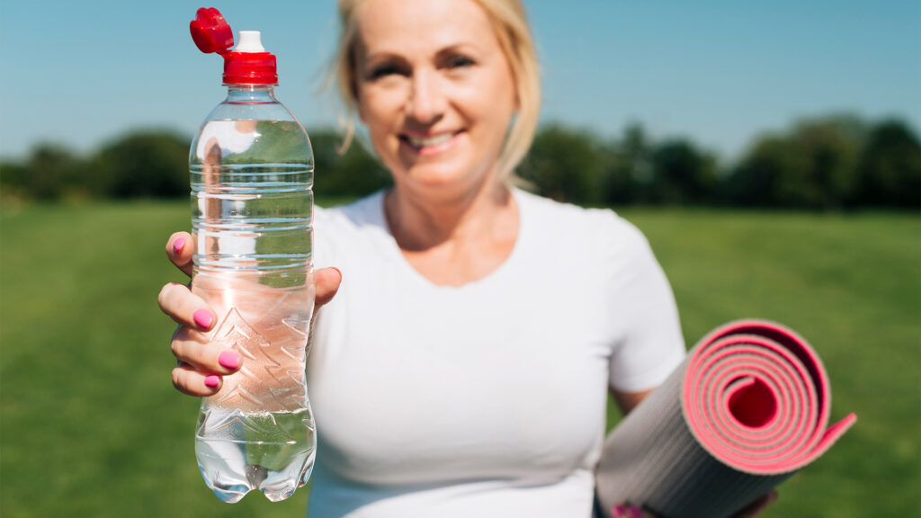 Person drinking water for daily hydration with electrolyte supplements
