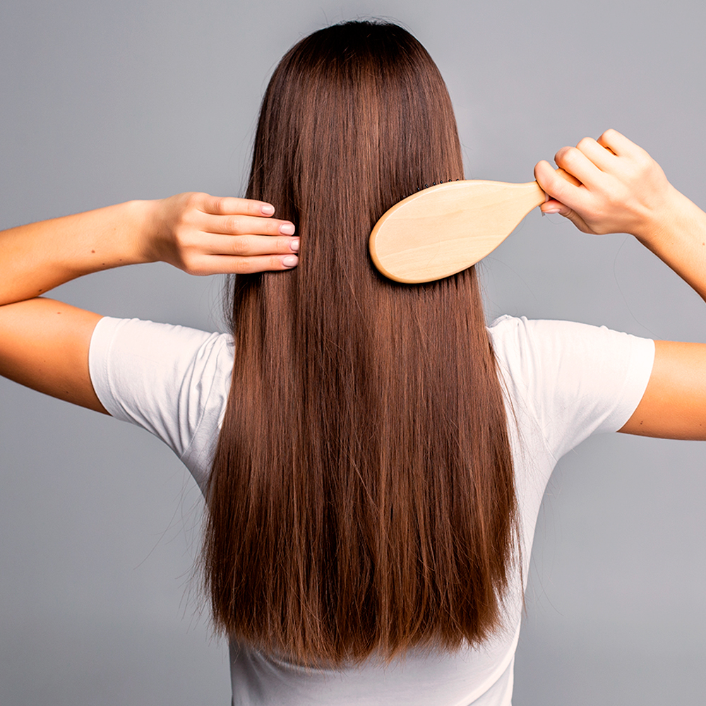 Woman with healthy, shiny hair, symbolizing the benefits of omega-3 and selenium for scalp health and hair growth.