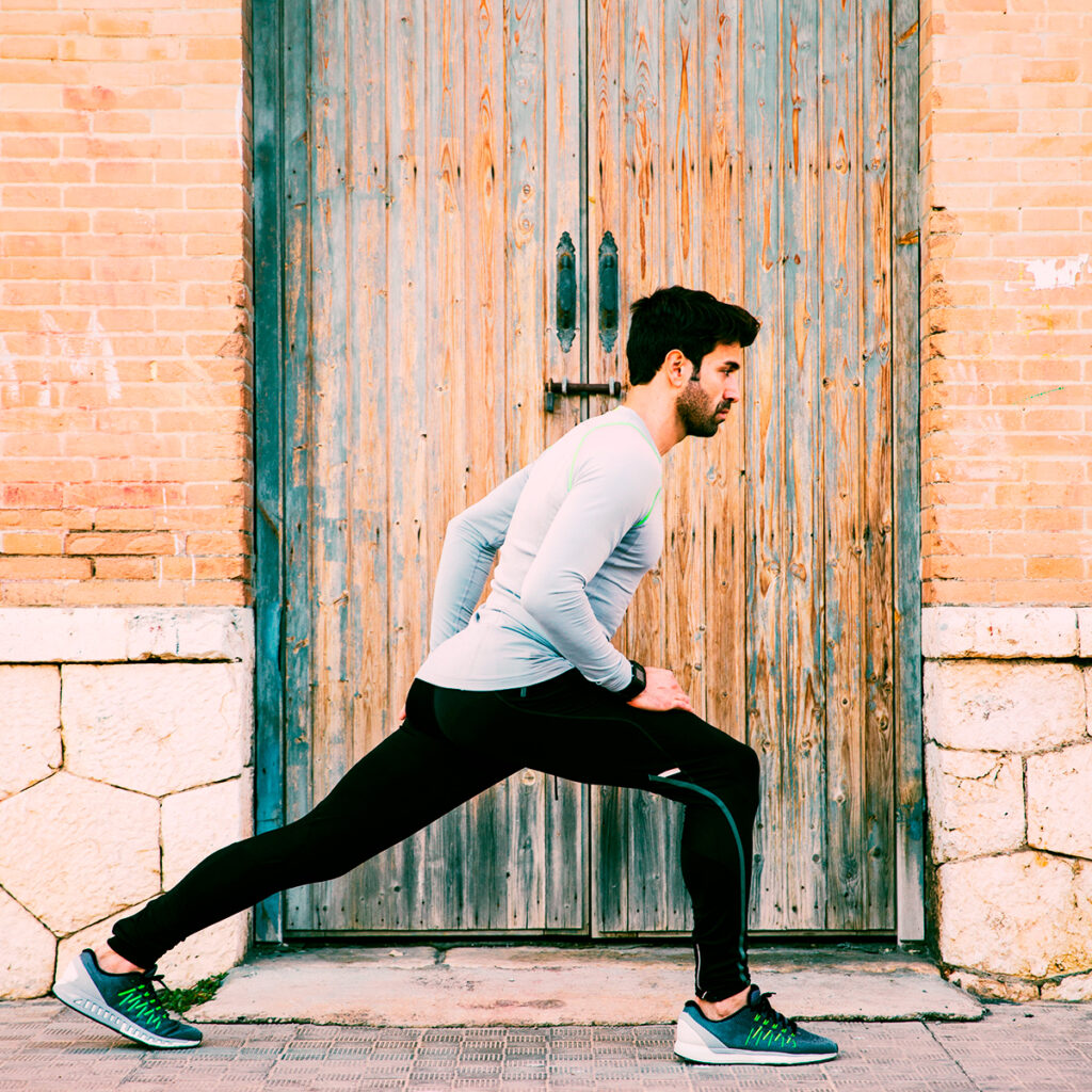Man stretching in front of a door, representing potassium that regulates blood pressure and prevents cramps.